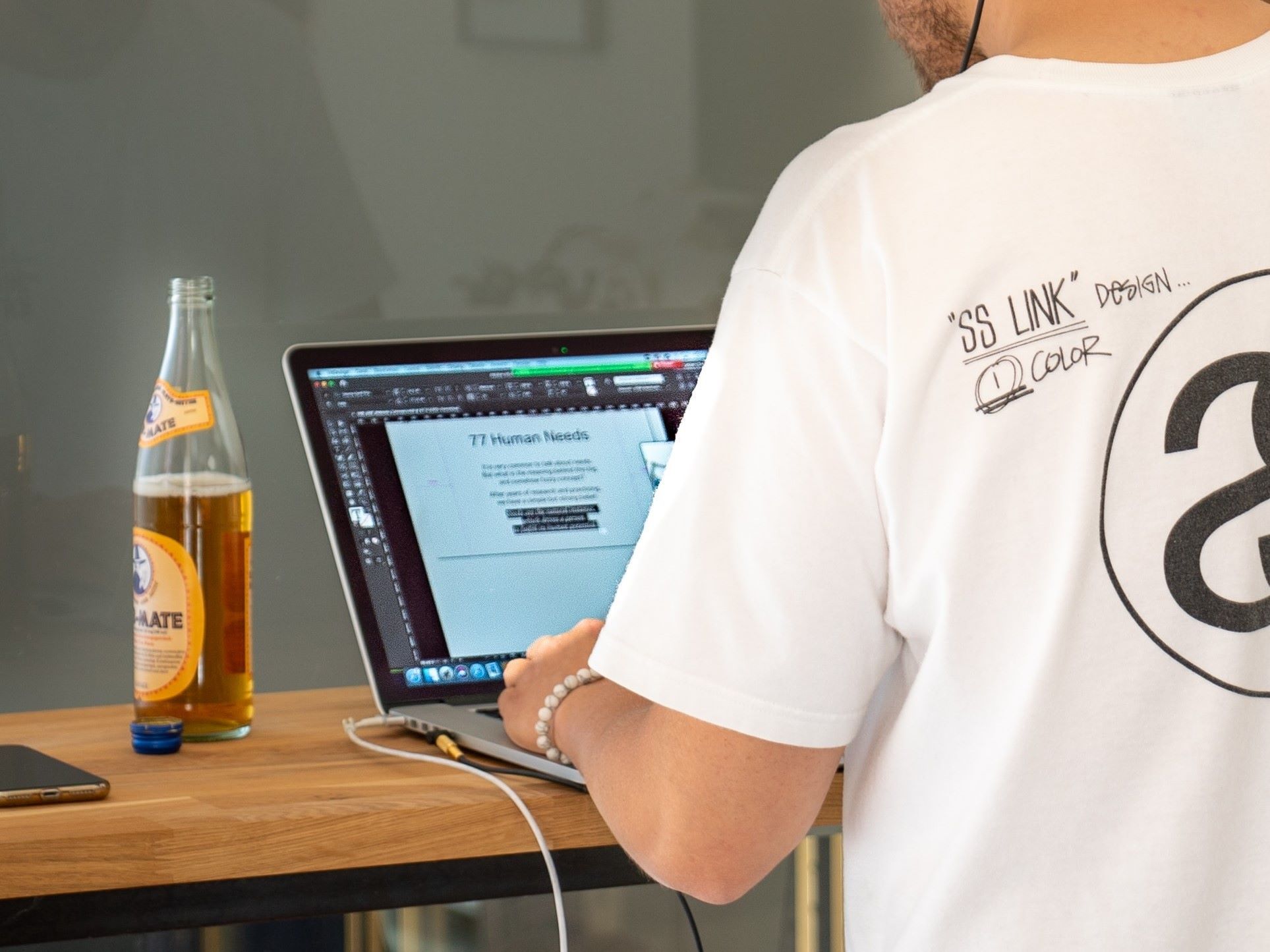 Beer and man working at a laptop