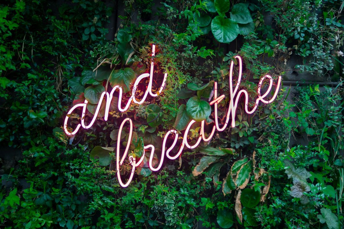 'And Breathe' neon sign